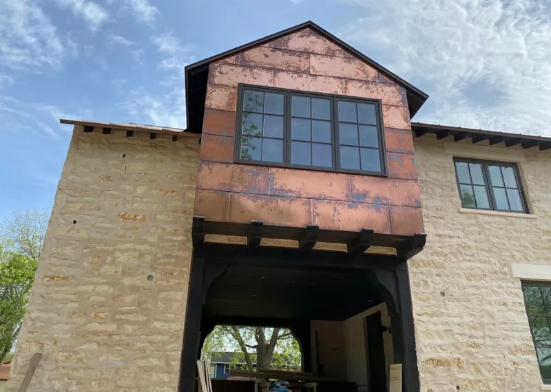 Copper metal panel facade on a stone building for Skylight Installation in Matteson